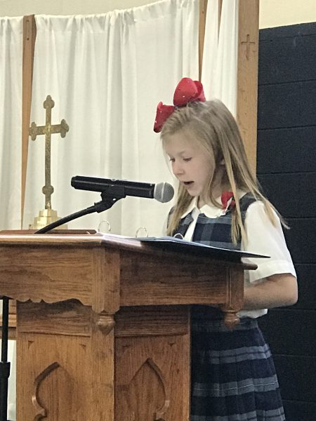 A girl speaks in a chapel