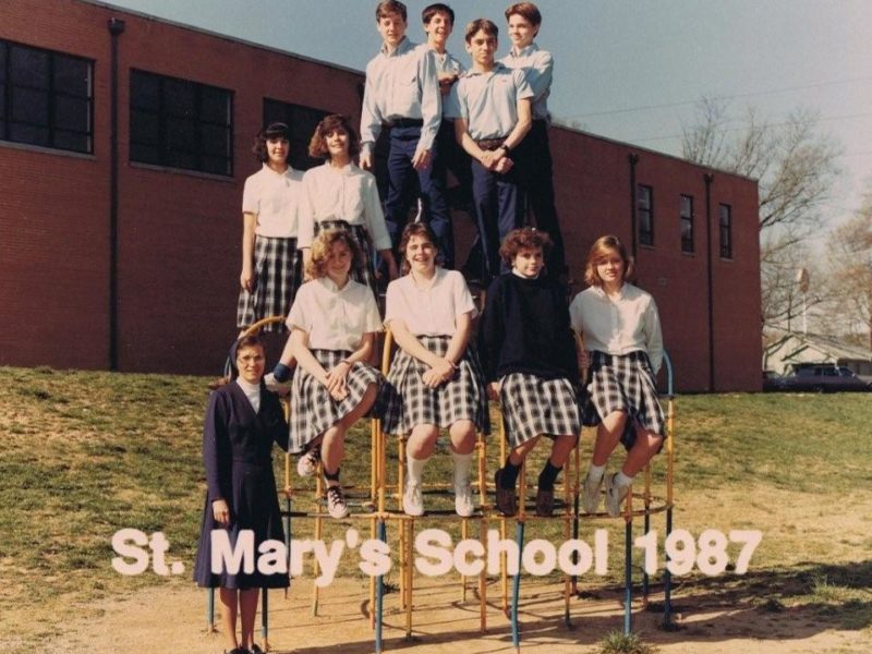 Students and a nun pose, with text that says St. Mary's School 1987